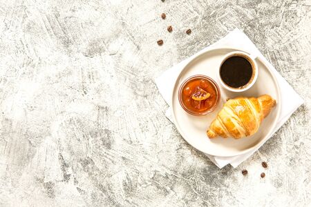 breakfast with croissants. fresh crispy croissants and coffee on a light 
background, top view/の写真素材