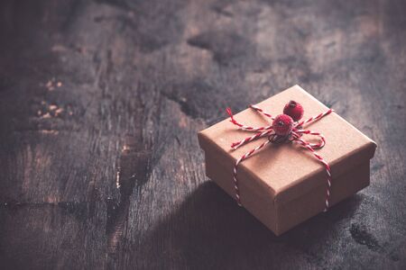 gift box with red bow on wooden table with copy space, christmas background.の写真素材