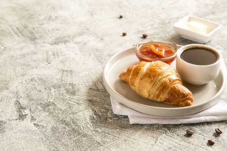 breakfast with croissants. fresh crispy croissants and coffee on a light 
background, top view/の写真素材