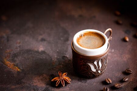 Coffee cup and beans on old kitchen table. turkish coffee and turkish delight with copyspace for your text.の写真素材