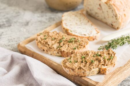 Fresh homemade chicken liver pate. Chicken liver pate on bread and in jar on a light background.の写真素材