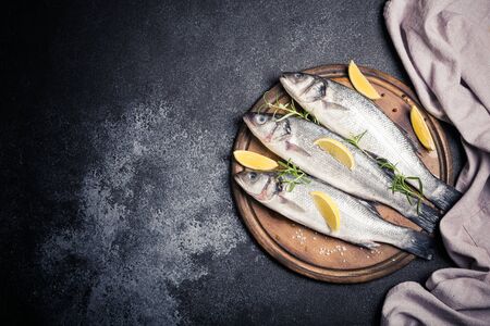 fresh raw whole sea bass. Raw seabass fish with spices and herbs ingredients. Top view with copy space.の写真素材