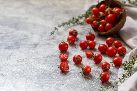 Tiny cherry tomatoes (ciliegini, pachino, cocktail). group of cherry tomatoes on a gray concrete background. ripe and juicy cherry tomatoes/の写真素材