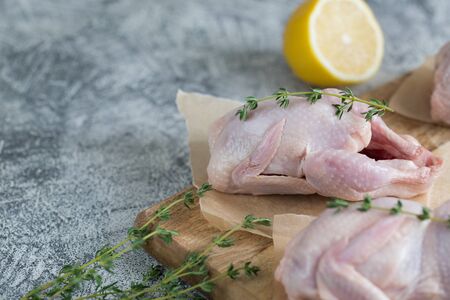 Raw uncooked quail. raw meat quails ready for cooking on a cutting board with copy space/の写真素材