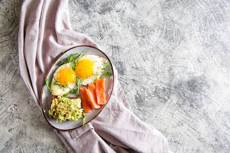 Egg breakfast. Healthy nutritious breakfast with eggs, salmon, avocado sandwich and sprouted pea seeds.の写真素材