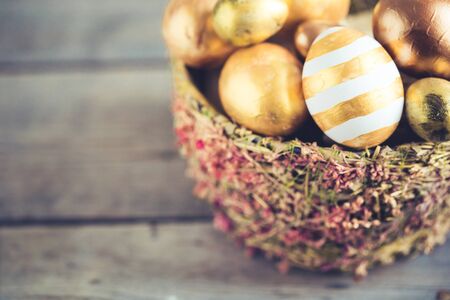 easter eggs colored with golden paint in differen patterns. Copy spaceの写真素材