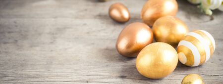 easter eggs colored with golden paint in differen patterns. Copy spaceの写真素材