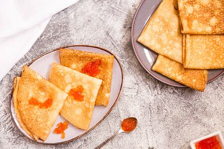 Traditional Russian pancakes with red caviar. Fried crepes with caviar and sour creamの写真素材