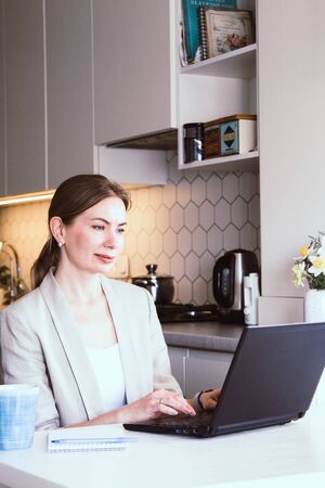 Beautiful young woman working from home. Many stuff to do today. woman work as a freelancer/の写真素材