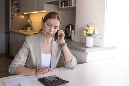 Beautiful young woman working from home. Many stuff to do today. woman work as a freelancer/の写真素材