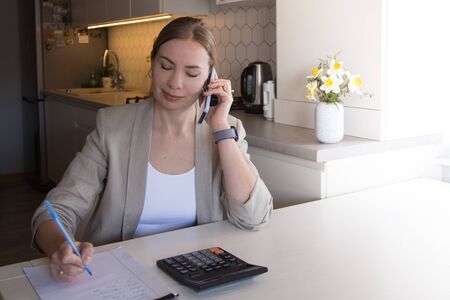 Beautiful young woman working from home. Many stuff to do today. woman work as a freelancer/の写真素材