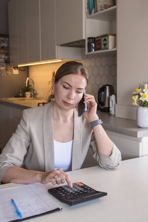 Beautiful young woman working from home. Many stuff to do today. woman work as a freelancer/の写真素材
