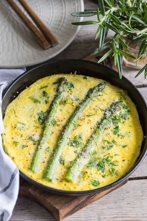 Asparagus with scrambled eggs. Omelet with asparagus  in a frying pan.の写真素材