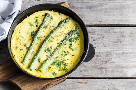 Asparagus with scrambled eggs. Omelet with asparagus  in a frying pan.の写真素材