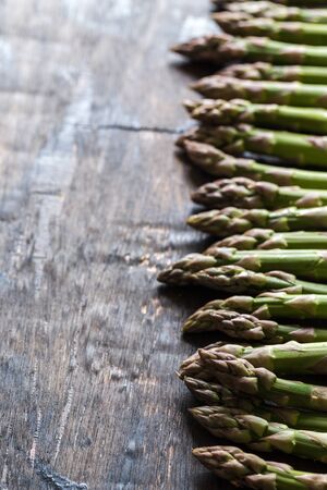 Green Asparagus. Bunches of green asparagus on a dark wooden rustic backgroundの写真素材