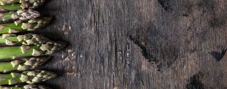 Green Asparagus. Bunches of green asparagus on a dark wooden rustic backgroundの写真素材