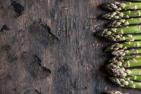 Green Asparagus. Bunches of green asparagus on a dark wooden rustic backgroundの写真素材