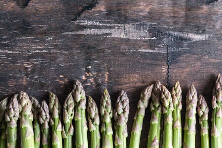 Green Asparagus. Bunches of green asparagus on a dark wooden rustic backgroundの写真素材