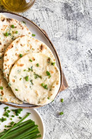 Onion naan - traditional indian bread. pita bread or scones with green onionsの写真素材