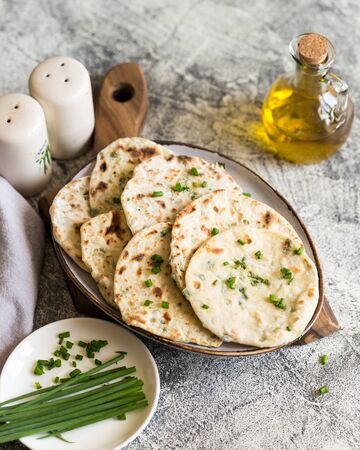 Onion naan - traditional indian bread. pita bread or scones with green onionsの写真素材