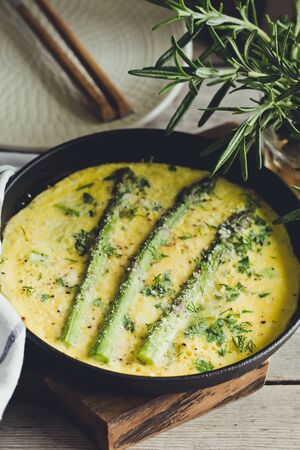 Asparagus with scrambled eggs. Omelet with asparagus  in a frying pan.の写真素材