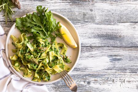 tagliatelle with spinach and asparagus. pasta with cream sauce and vegetablesの写真素材