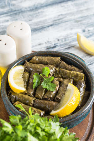 Dolma - Stuffed greek wine leaves (dolmades) on a blue wooden backgroundの写真素材