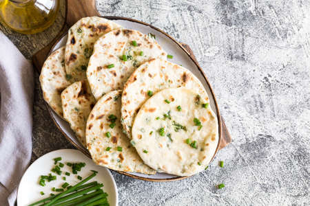 Onion naan - traditional indian bread. pita bread or scones with green onionsの写真素材