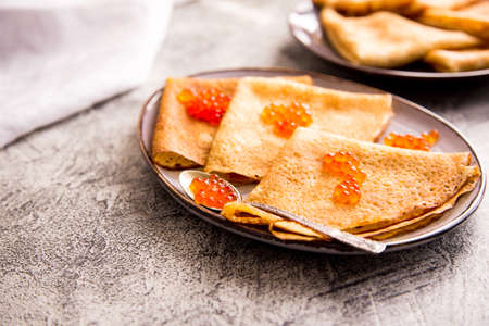 Traditional Russian pancakes with red caviar. Fried crepes with caviar and sour creamの写真素材