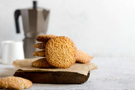 cookies with sesame seeds on gray concrete background. Healthy snack with sesame /の写真素材