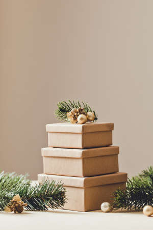 Brown gift boxes. Stacks of Christmas presents with Christmas tree. copy space /の写真素材