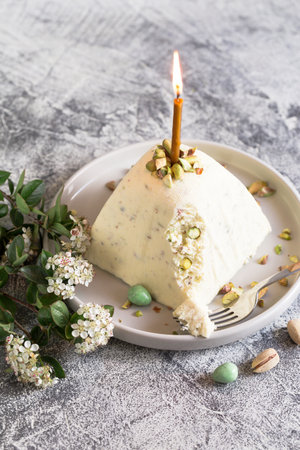 Paskha and kulich with pistachios. Traditional Russian Orthodox Easter Quark Dessert Curd. Easter food background. Traditional cottage cheese cakeの写真素材