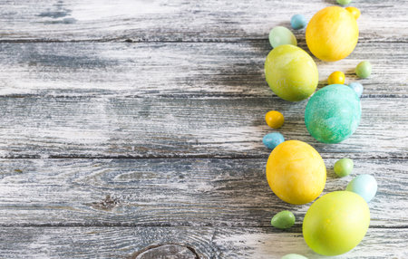 colorful easter eggs on shabby wooden blue backgroundの写真素材