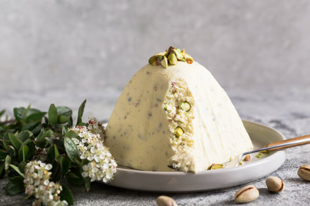 Paskha and kulich with pistachios. Traditional Russian Orthodox Easter Quark Dessert Curd. Easter food background. Traditional cottage cheese cakeの写真素材