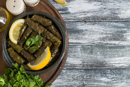Dolma - Stuffed greek wine leaves (dolmades) on a blue wooden backgroundの写真素材