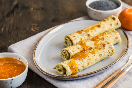 poppy seed crepes (blinis). pancakes with poppy seeds and tangerine jam.の写真素材