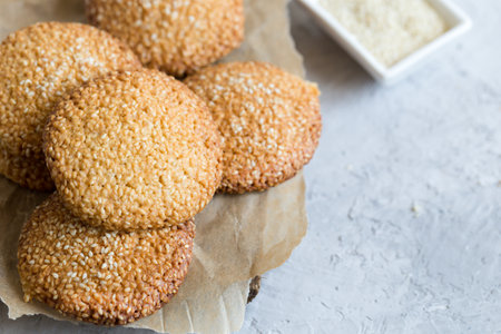 cookies with sesame seeds on gray concrete background. Healthy snack with sesame /の写真素材