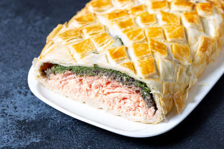 Homemade Salmon Wellington. It is made from Salmon Fish, spinach, mushrooms, spices, herbs and puff pastry. Copy spaceの写真素材