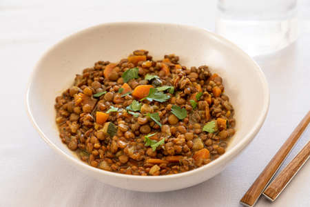 lentils with vegetables in a plate on the dining table. comfort homemade food, vegetarian lentils.の写真素材
