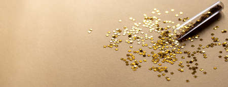 Golden sparkles stars on gold holiday background. Festive backdrop for your projects