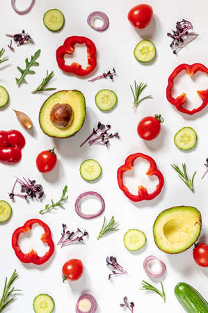 Creative layout of tomatoes, cucumbers, bell peppers, avocados and salads. flat lay. Food concept. place for your text.の写真素材