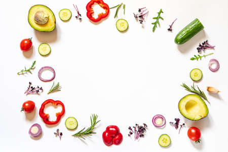 Creative layout of tomatoes, cucumbers, bell peppers, avocados and salads. flat lay. Food concept. place for your text.の写真素材