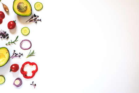 Creative layout of tomatoes, cucumbers, bell peppers, avocados and salads. flat lay. Food concept. place for your text.の写真素材