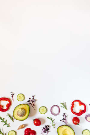 Creative layout of tomatoes, cucumbers, bell peppers, avocados and salads. flat lay. Food concept. place for your text.の写真素材