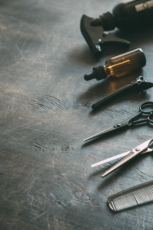 Set of professional hairdresser tools with combs and styling on dark wooden background top view mock up.の写真素材