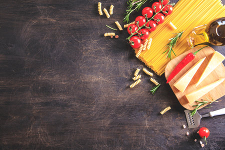 Uncooked pasta on wooden background. Top view. Raw pasta with ingredients for cooking. Food concept. Italian food.の写真素材
