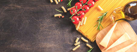 Uncooked pasta on wooden background. Top view. Raw pasta with ingredients for cooking. Food concept. Italian food.の写真素材