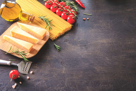 Uncooked pasta on wooden background. Top view. Raw pasta with ingredients for cooking. Food concept. Italian food.の写真素材