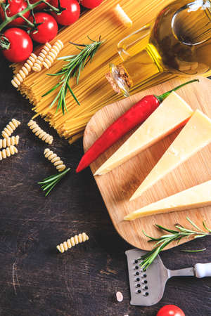 Uncooked pasta on wooden background. Top view. Raw pasta with ingredients for cooking. Food concept. Italian food.の写真素材