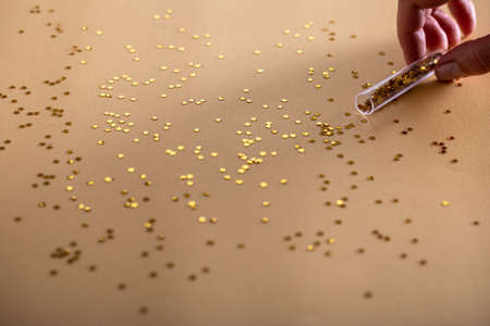 Golden sparkles stars on gold holiday background. Festive backdrop for your projectsの写真素材
